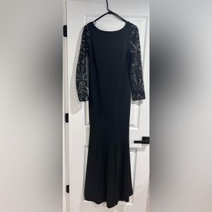 Elegant black dress with embellished sleeve. Formal dress.